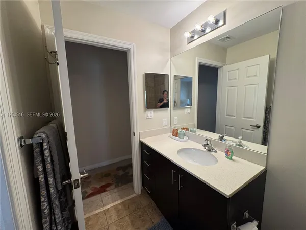 a bathroom with a sink double vanity and a mirror