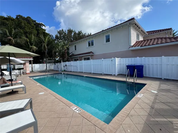 a swimming pool with outdoor seating and yard