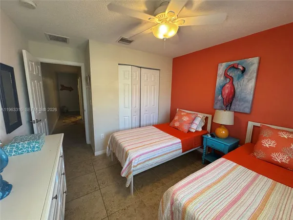 a bedroom with two beds and a chandelier