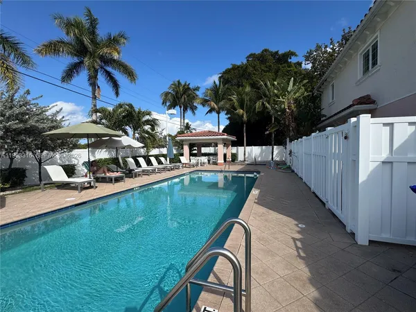 a view of a patio with swimming pool table and chairs