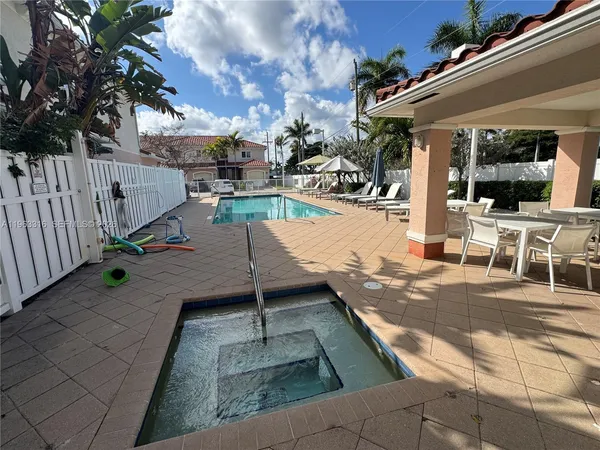 a view of a house with swimming pool and sitting area