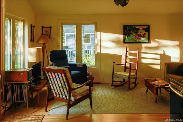 a view of a livingroom with furniture and a window