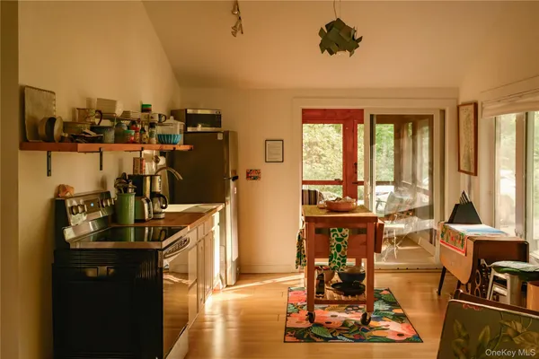 a view of a living room with furniture and floor to ceiling window