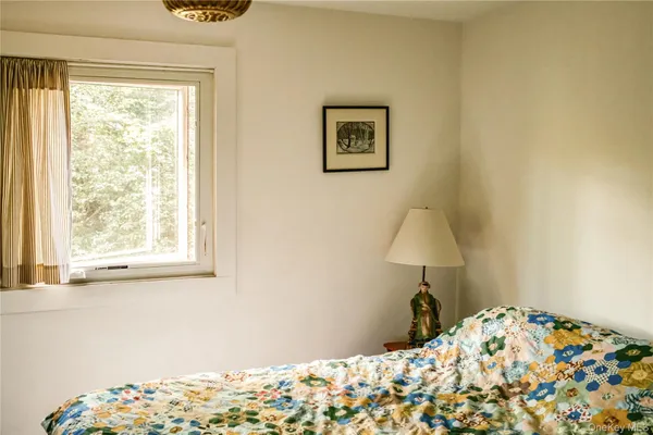 a view of a livingroom with furniture and a window