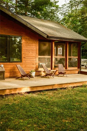 a view of a house with yard patio and furniture
