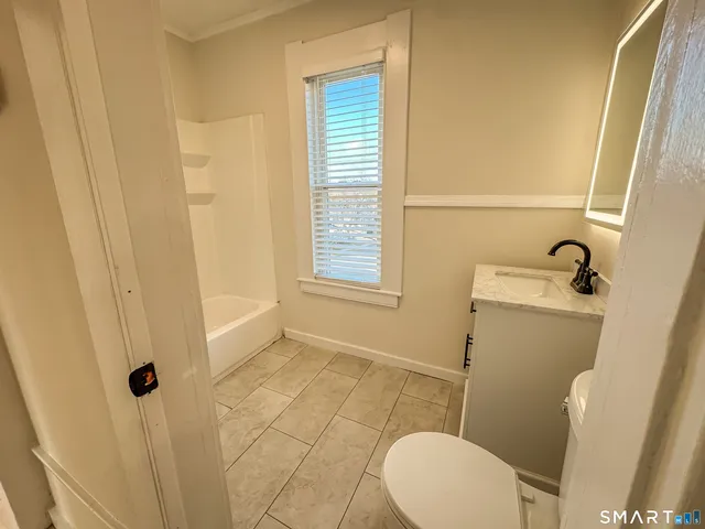 a bathroom with a bath tub with a shower