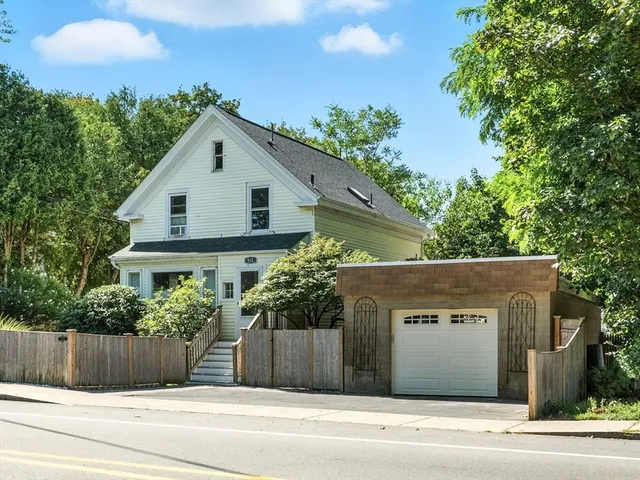 a house that has a tree in front of it