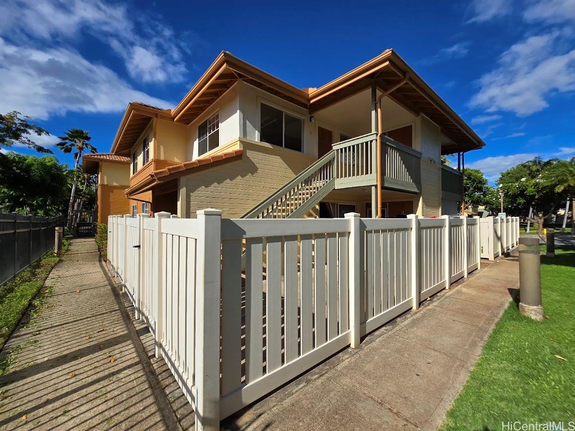 a front view of a house with wooden fence