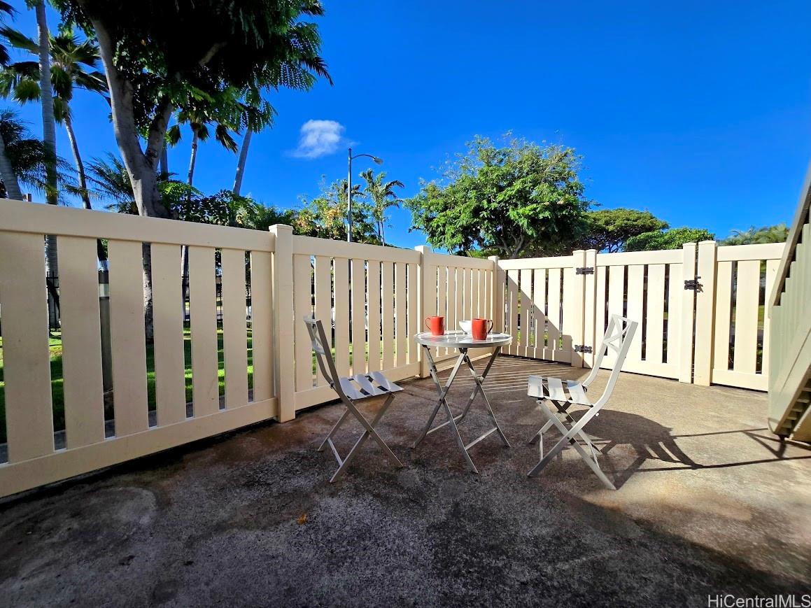 91-1109 Namahoe Street, Unit 1L Kapolei, HI 96707 - Photo 16 of 18 a view of wooden fence with a bench