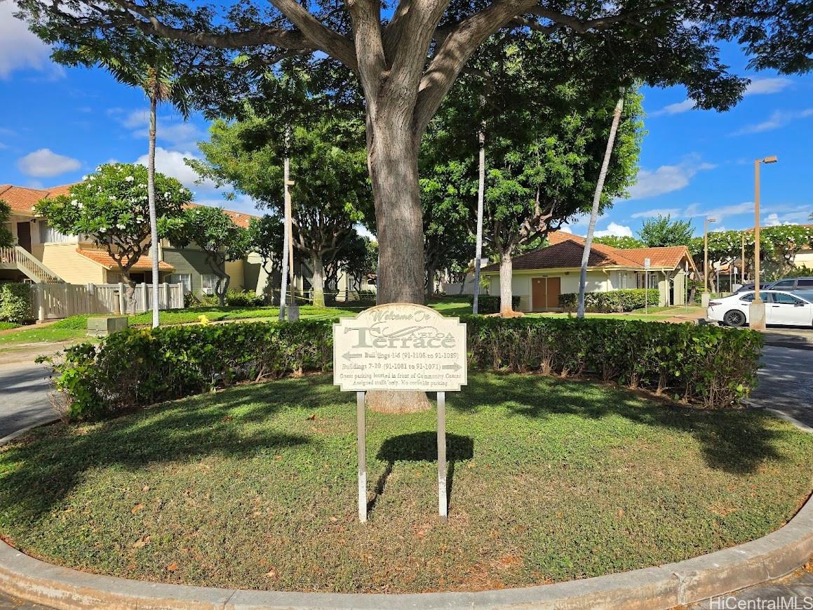91-1109 Namahoe Street, Unit 1L Kapolei, HI 96707 - Photo 18 of 18 a front view of a house with garden