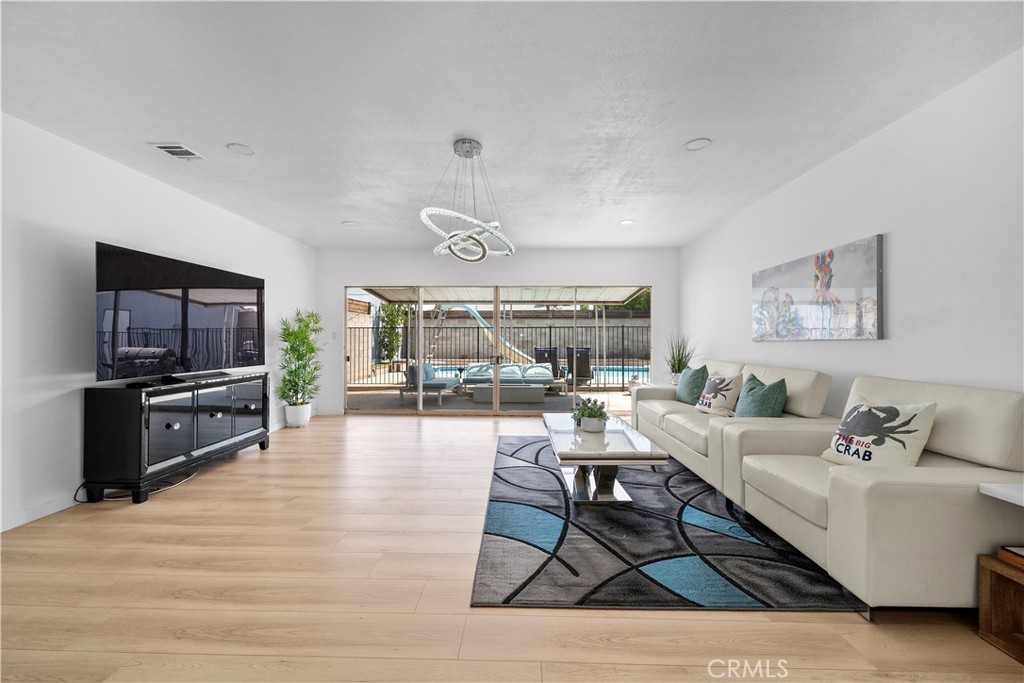 1158 North Ivescrest Avenue Covina, CA 91724 - Photo 11 of 27 a living room with furniture and a flat screen tv