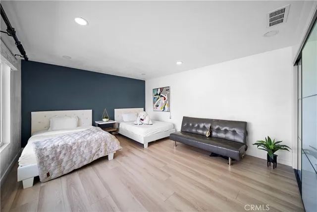 a bedroom with two beds and a couch