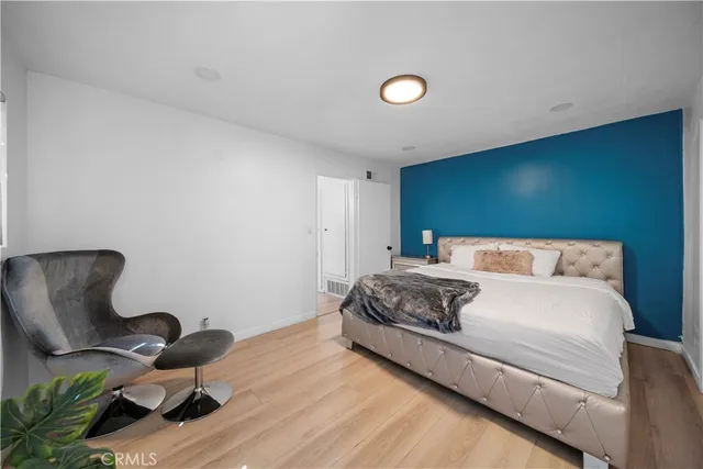 a bedroom with a bed and chair