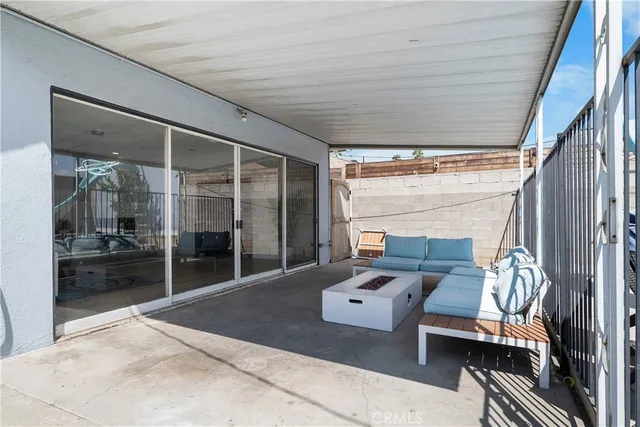 a balcony with furniture and a potted plant