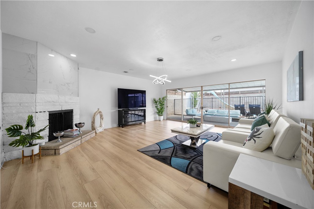 1158 North Ivescrest Avenue Covina, CA 91724 - Photo 6 of 27 a living room with fireplace furniture and a flat screen tv