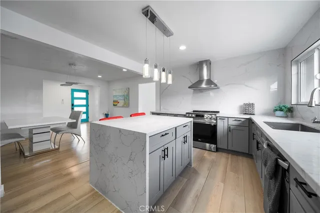 a kitchen with a stove sink and cabinets