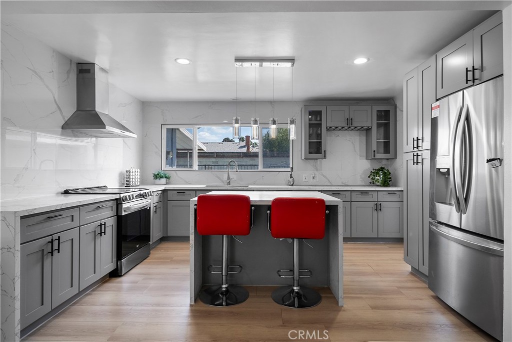 1158 North Ivescrest Avenue Covina, CA 91724 - Photo 9 of 27 a kitchen with stainless steel appliances granite countertop a kitchen island hardwood floor sink stove and granite counter top