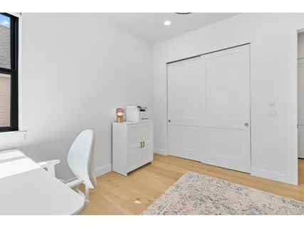 a bathroom with a granite countertop sink a toilet and shower