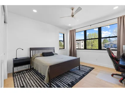 a bedroom with a bed a desk and chair