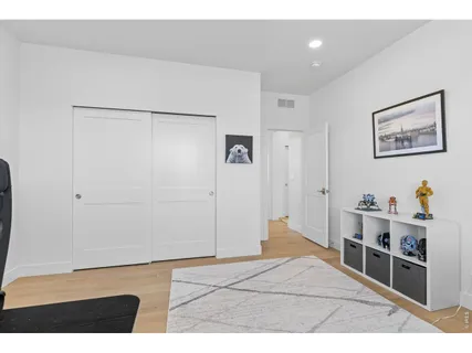 a bedroom with a bed a dresser and a window