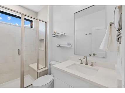 a bedroom with a bed and a chair