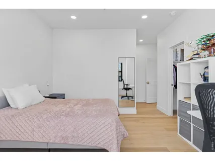 a living room with furniture wooden floor and a flat screen tv