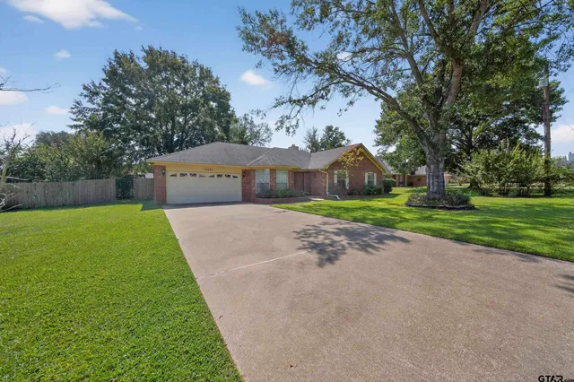 a view of a house with a yard and garage