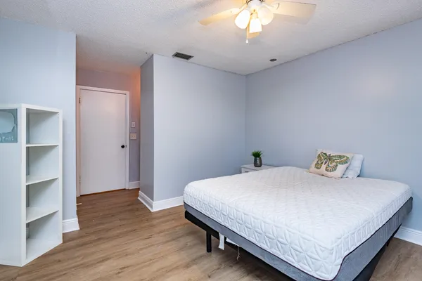 a bedroom with a bed and a chandelier