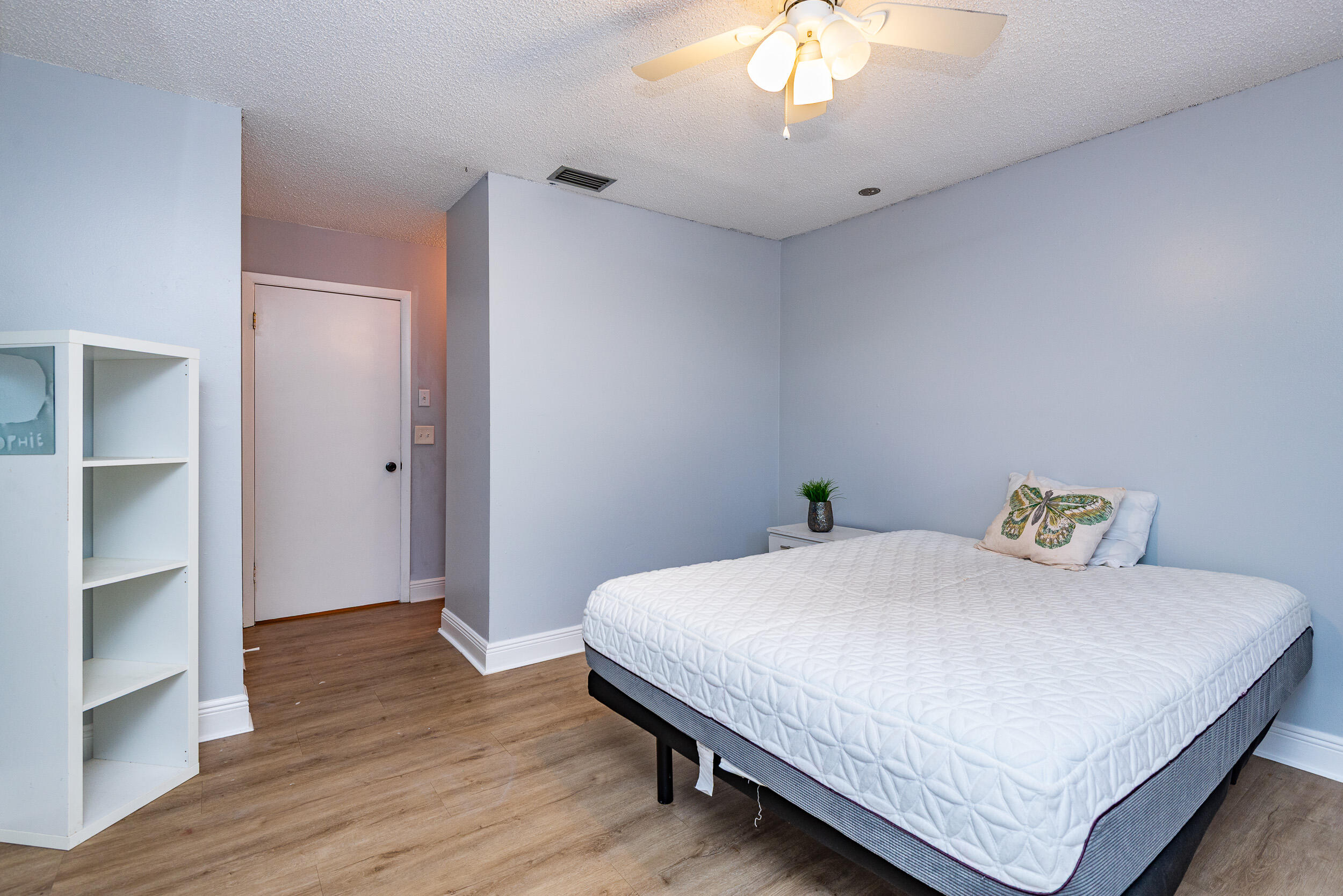 9375 Southwest 61st Way, Unit D Boca Raton, FL 33428 - Photo 15 of 30 a bedroom with a bed and a chandelier