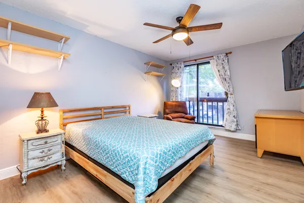 a bedroom with a bed and a chandelier