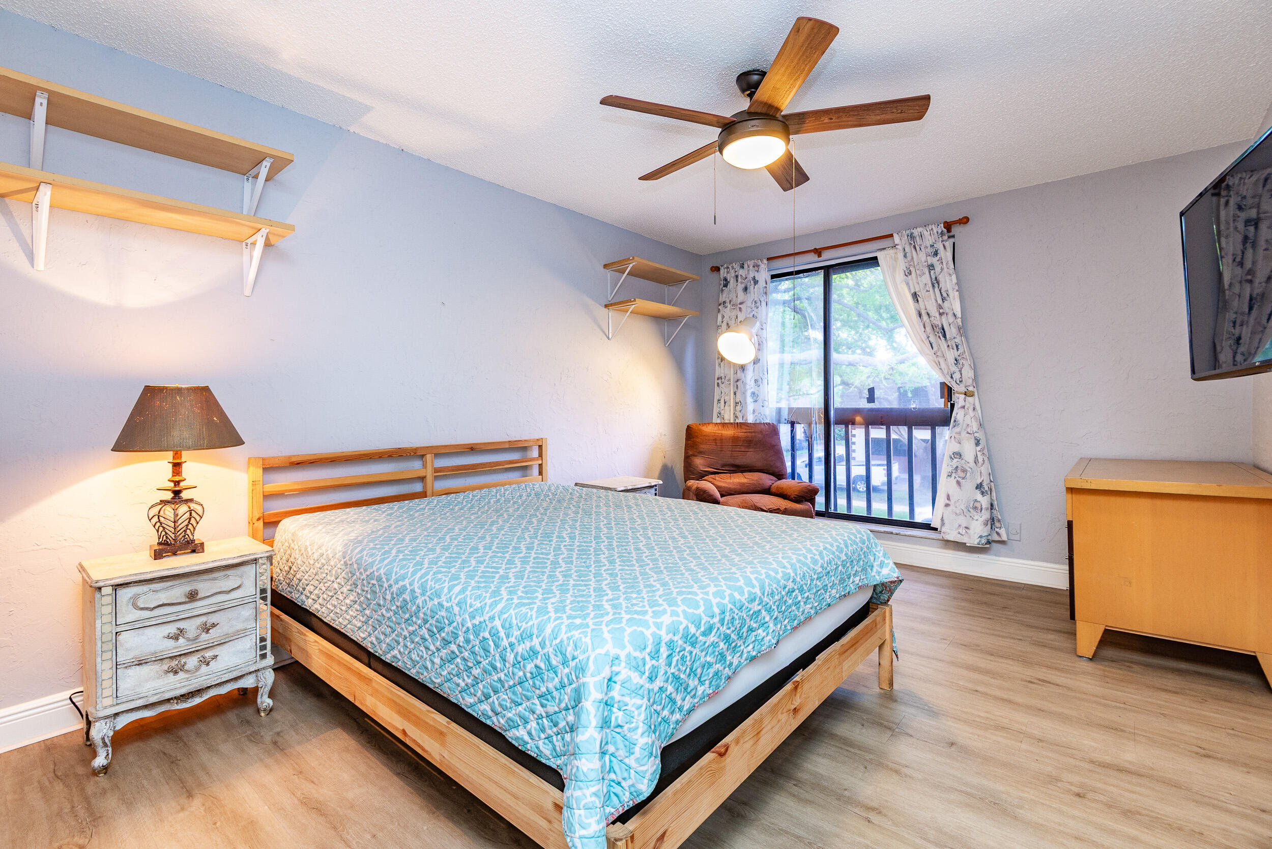 9375 Southwest 61st Way, Unit D Boca Raton, FL 33428 - Photo 19 of 30 a bedroom with a bed and a chandelier