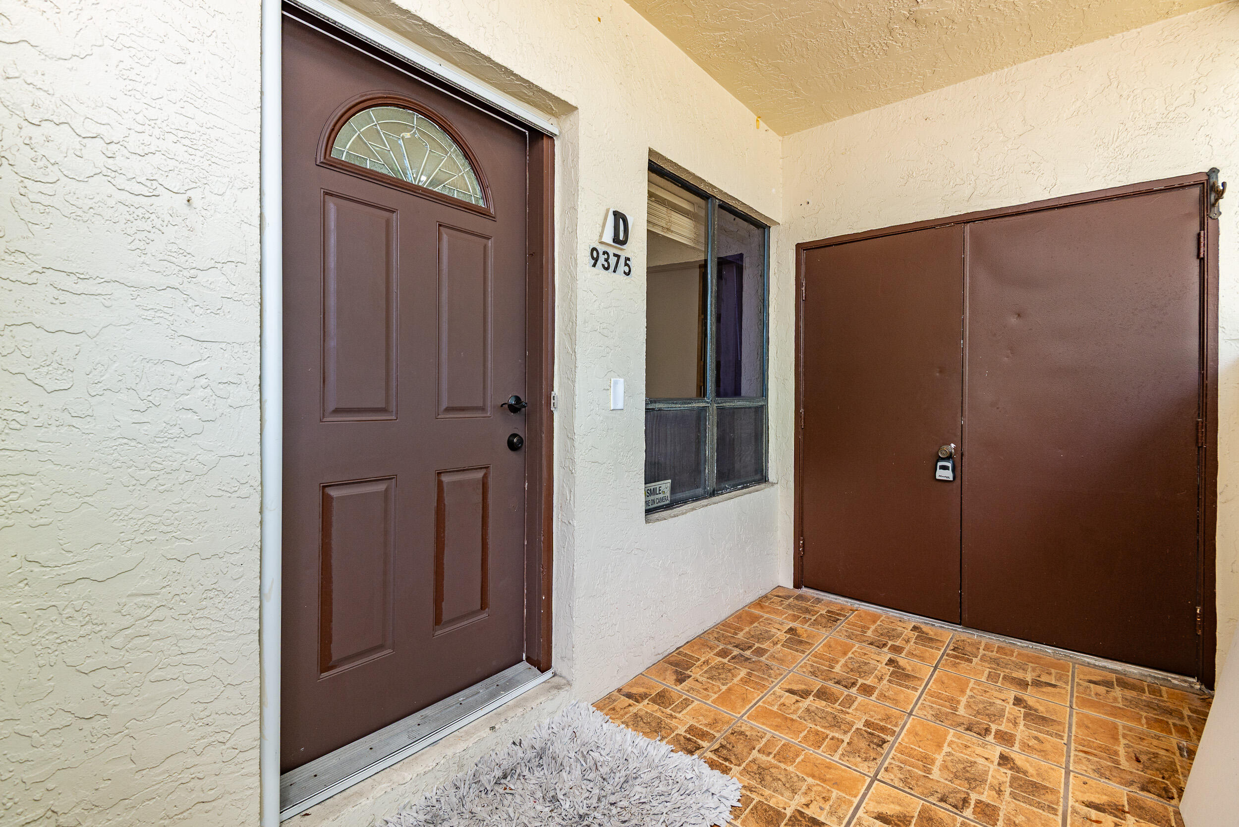 9375 Southwest 61st Way, Unit D Boca Raton, FL 33428 - Photo 23 of 30 a view of a hallway with wooden floor and a cabinet