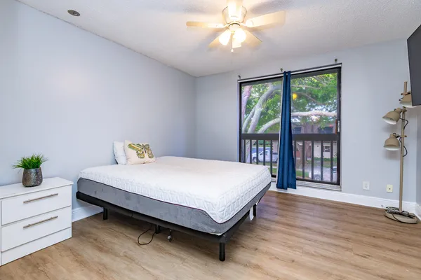 a bed sitting in a spacious bedroom next to a window