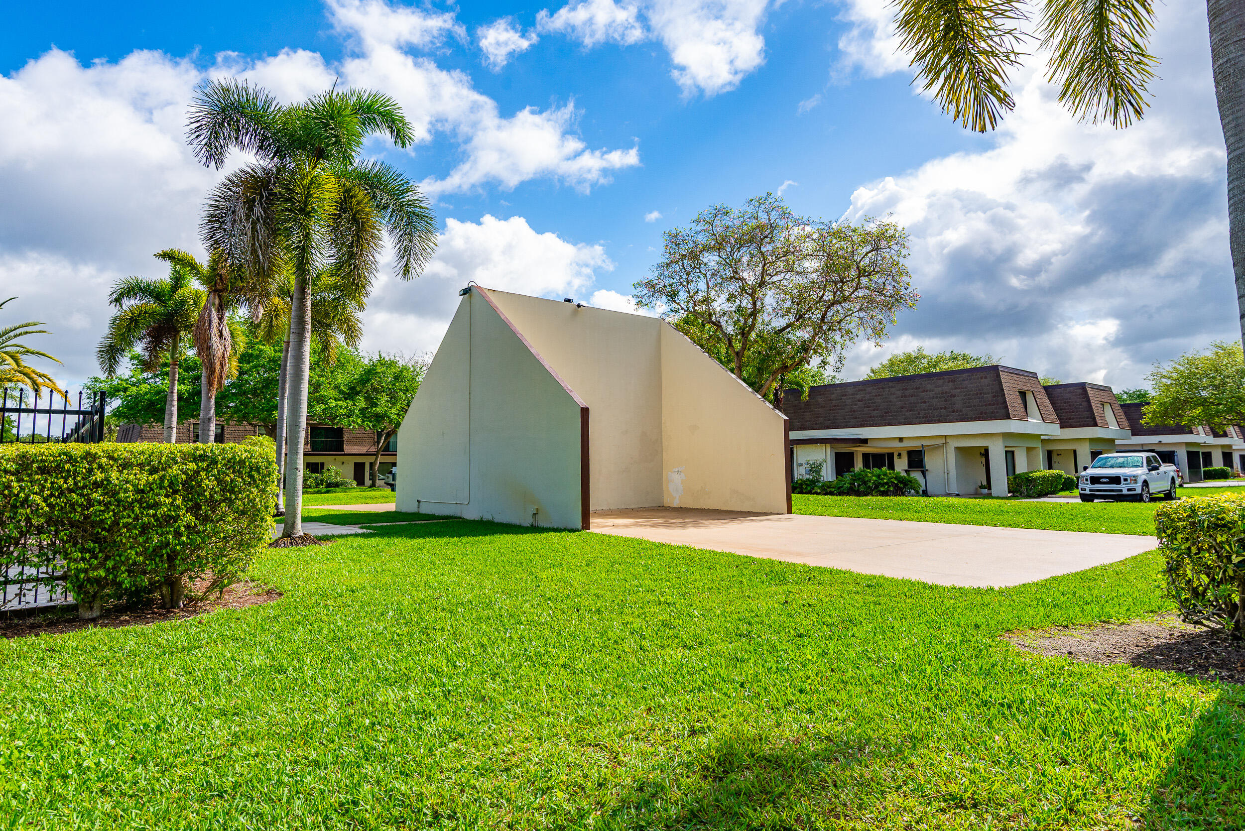 9375 Southwest 61st Way, Unit D Boca Raton, FL 33428 - Photo 29 of 30 a front view of a house with a yard and garage