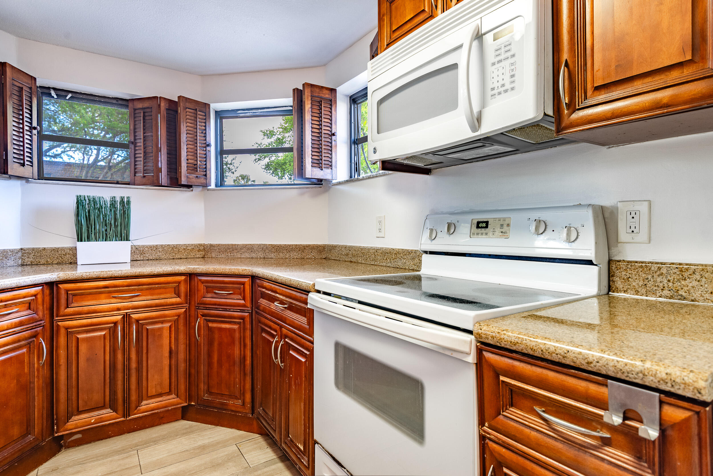 9375 Southwest 61st Way, Unit D Boca Raton, FL 33428 - Photo 5 of 30 a kitchen with stainless steel appliances granite countertop a sink dishwasher stove and cabinets
