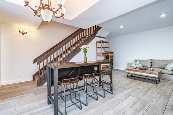 a view of entryway livingroom and hall with wooden floor