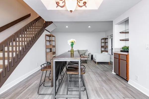 a view of a dining room with furniture and wooden floor