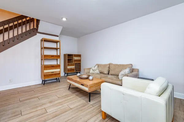 a living room with furniture and a wooden floor
