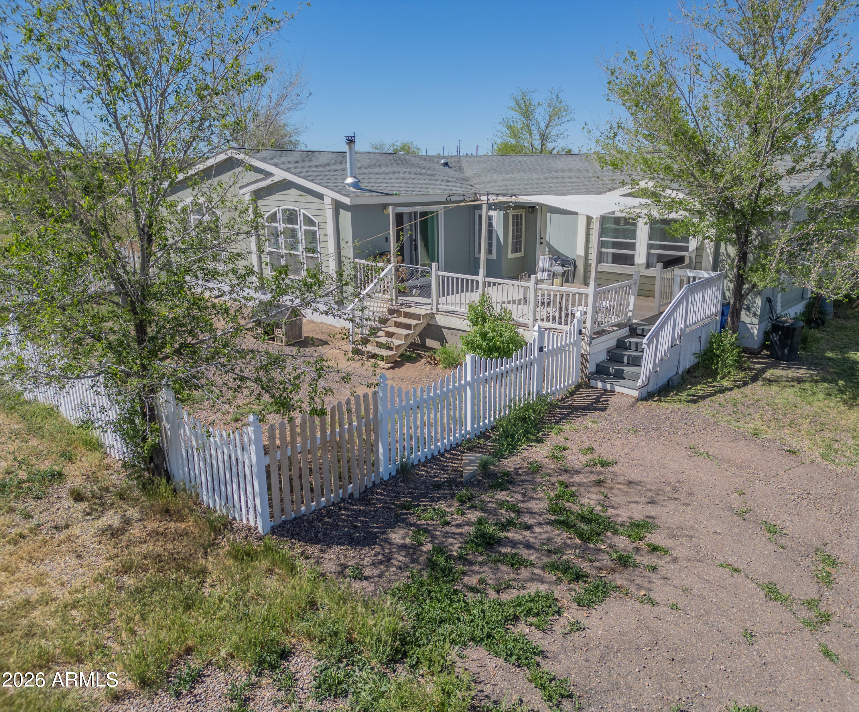 1401 Ranch Road Taylor, AZ 85939 - Photo 2 of 61 a front view of a house with a yard and potted plants
