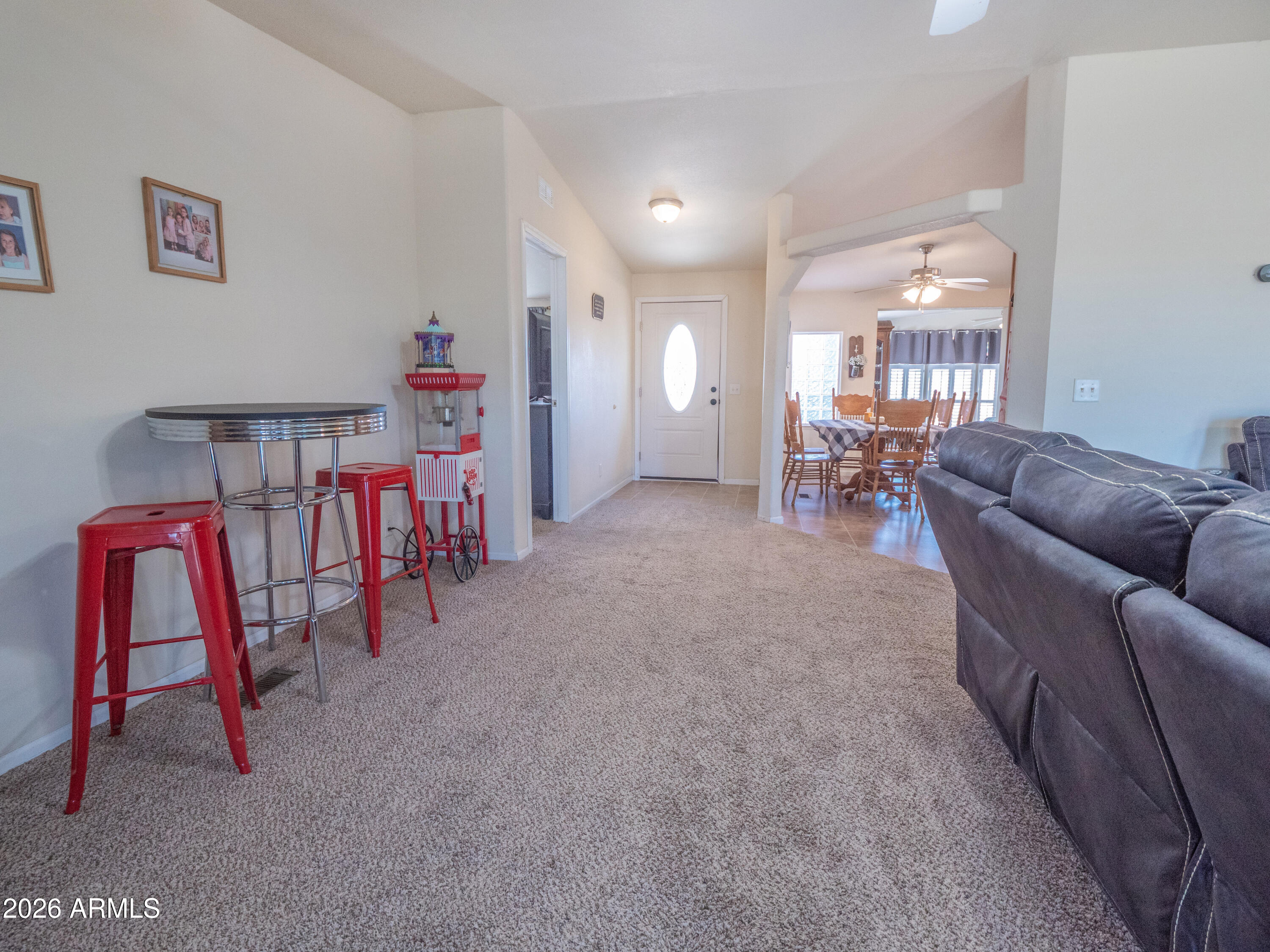 1401 Ranch Road Taylor, AZ 85939 - Photo 26 of 61 a living room with furniture and a dining table with projector