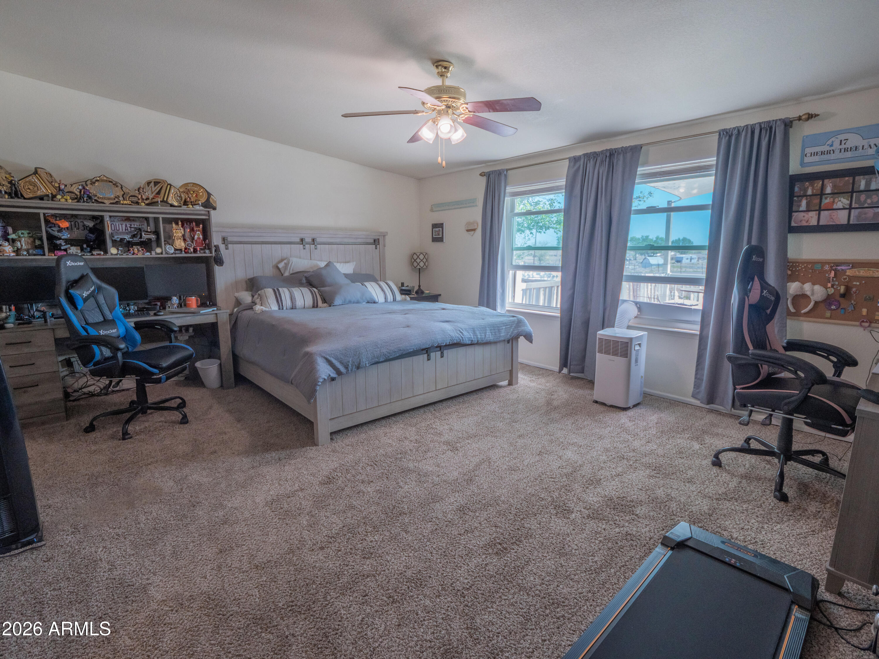 1401 Ranch Road Taylor, AZ 85939 - Photo 29 of 61 a spacious bedroom with a bed a table and a chandelier
