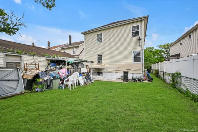 a view of a house with a yard and sitting area