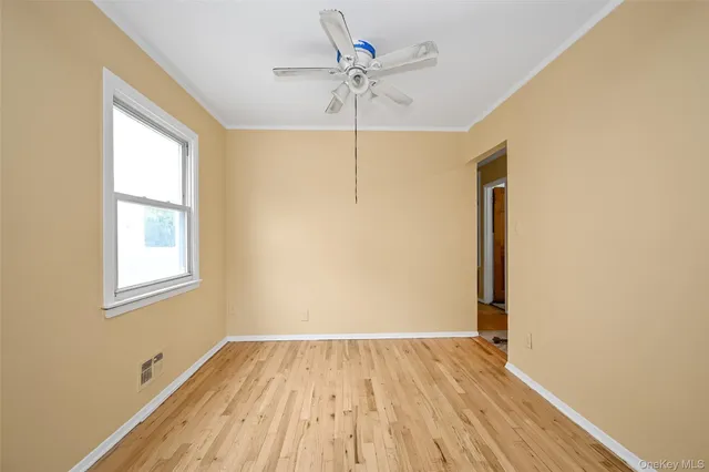a view of a room with wooden floor and a window