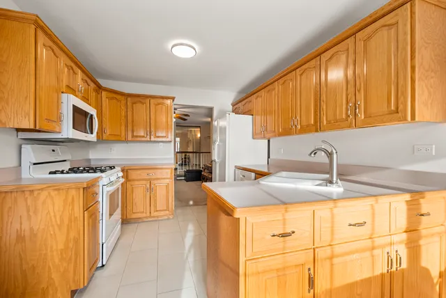 a kitchen with stainless steel appliances granite countertop a sink and cabinets