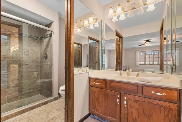 a bathroom with a double vanity sink mirror and shower