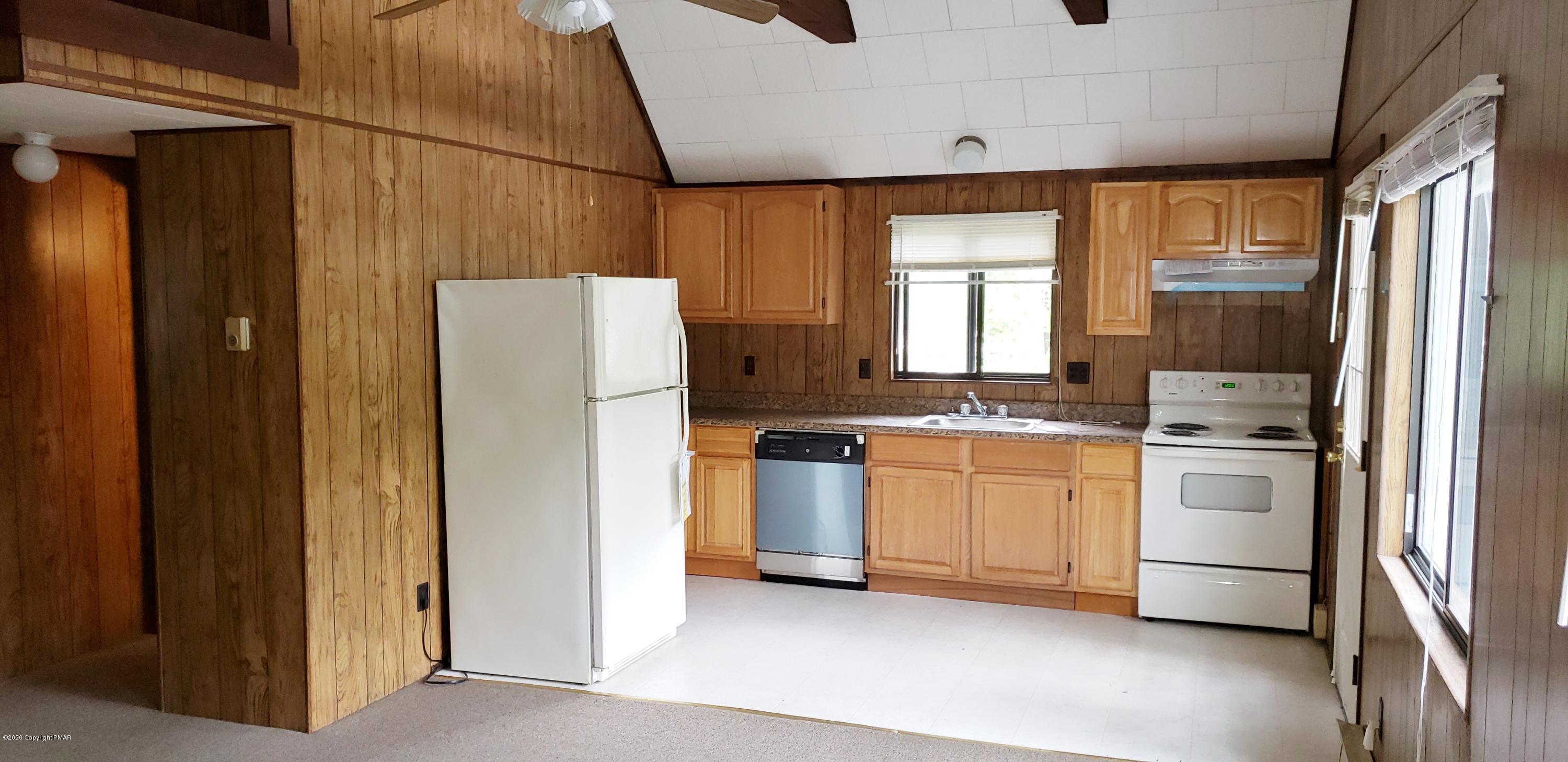 164 Spring Drive Dingmans Ferry, PA 18328 - Photo 2 of 11 a kitchen with a refrigerator and a stove