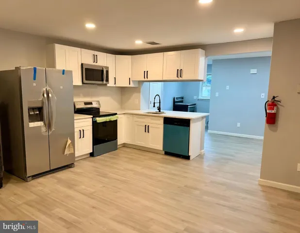 a bedroom with a bed a mirror and lamp