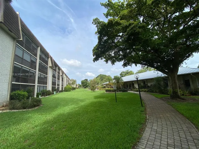 a view of a backyard with plants and a garden