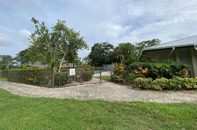 a view of a garden with a bench and trees