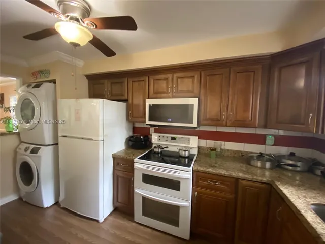 a kitchen with refrigerator a stove and a sink